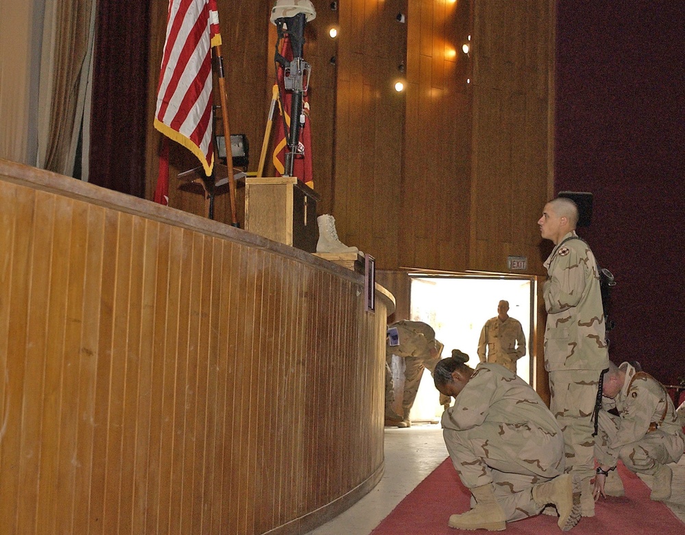 Three Soldiers pay their final respect at the memorial