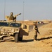 Cavalry Scouts signal local traffic to stop during patrol
