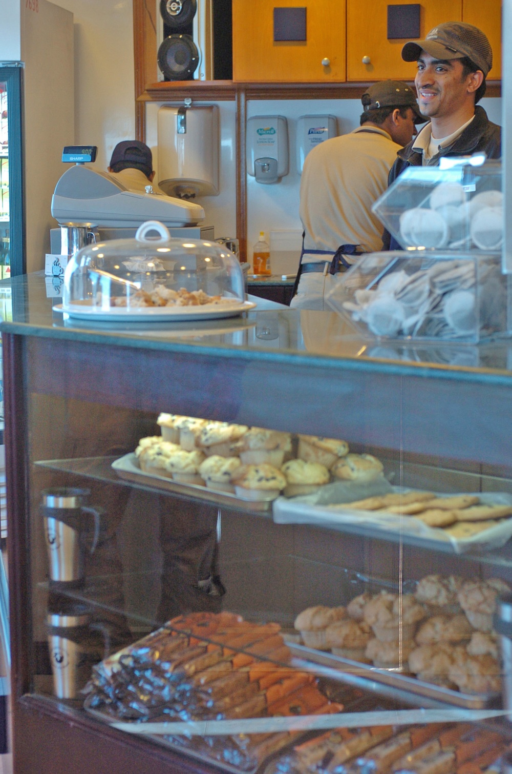 Imran Thange stands over fresh baked muffins