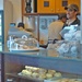 Imran Thange stands over fresh baked muffins