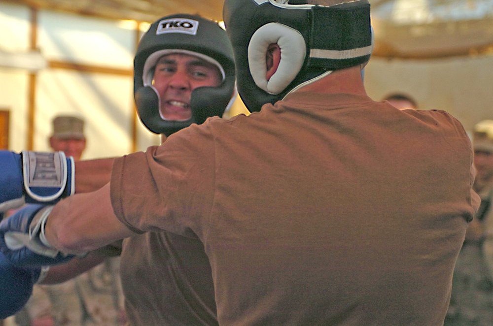 Spc. Samuel Loveless swings at Lt. Chris Giorgi