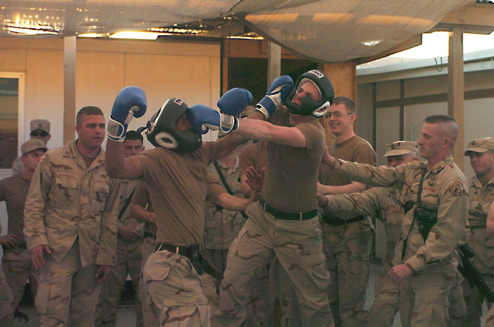 Sgt. Wayne Meyers lands a jab on Spc. Donald Mack