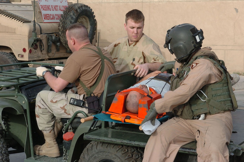 Sgt. Miller and Medics Drive an Patient From the Landing Zone