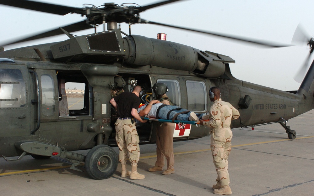 Medics Load a Casualty Onto a MEDEVAC Blackhawk Helicopter