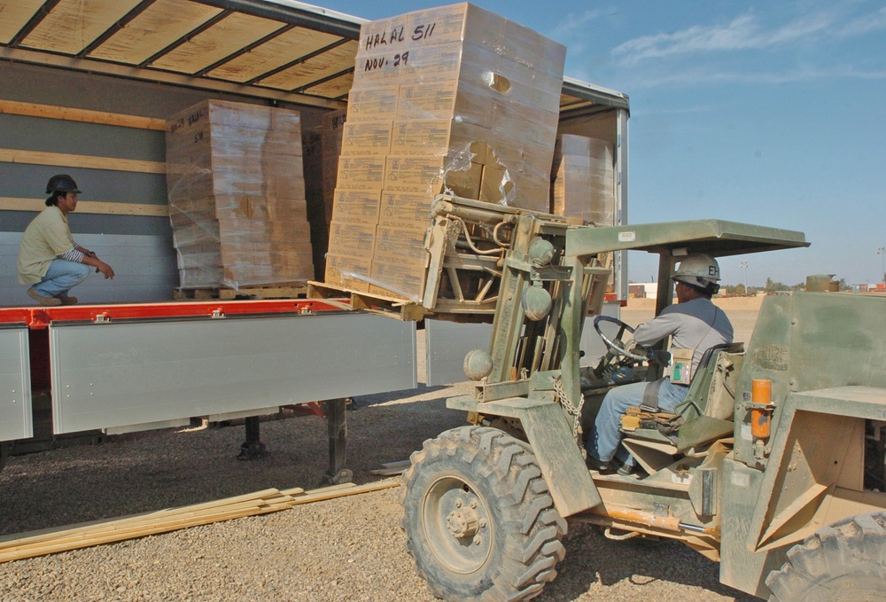 Third-country Nationals Load Pallets on to Trucks