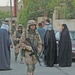 Estonian soldiers walk past an Iraqi wedding party
