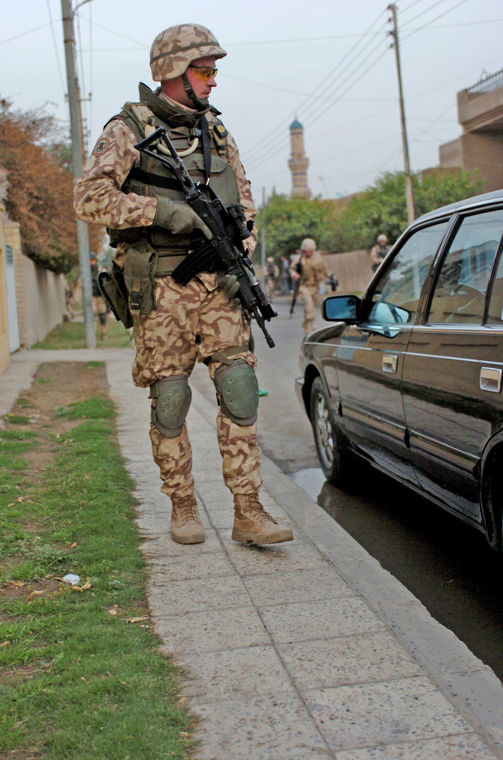 Estonian Cpl. Pettai looks in a parked car while patroling