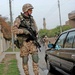 Estonian Cpl. Pettai looks in a parked car while patroling