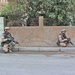 Estonian soldiers await orders to begin patrolling the street