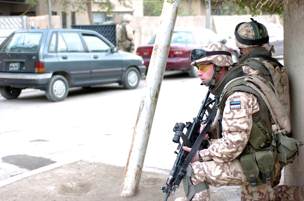 Estonian soldiers guard a street corner in Western Baghdad
