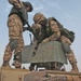 Estonian soldiers mount a .50-caliber machine gun on the turret