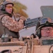 Estonian soldiers stand guard in an armored personnel carrier