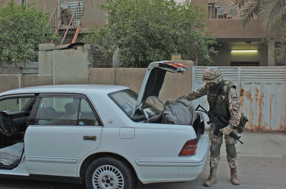 Estonian Cpl. Eiko Oim searches a car during patrols