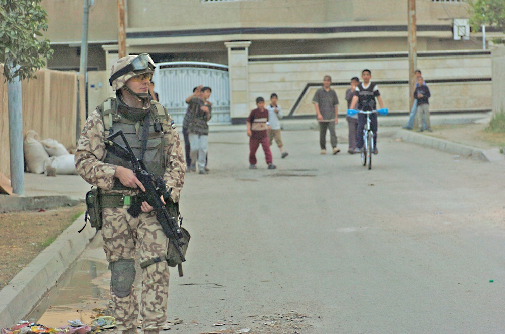 Iraqi children follow Estonian Sgt. Ansar while he patrols