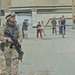 Iraqi children follow Estonian Sgt. Ansar while he patrols