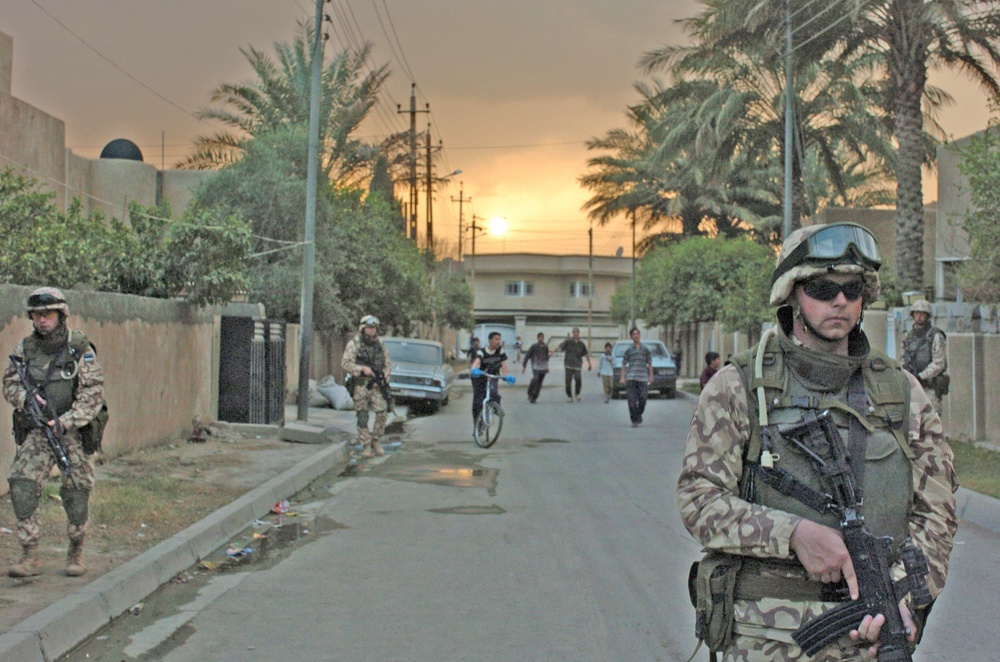 Iraqi children follow Estonian Sgt. Ansar while he patrols