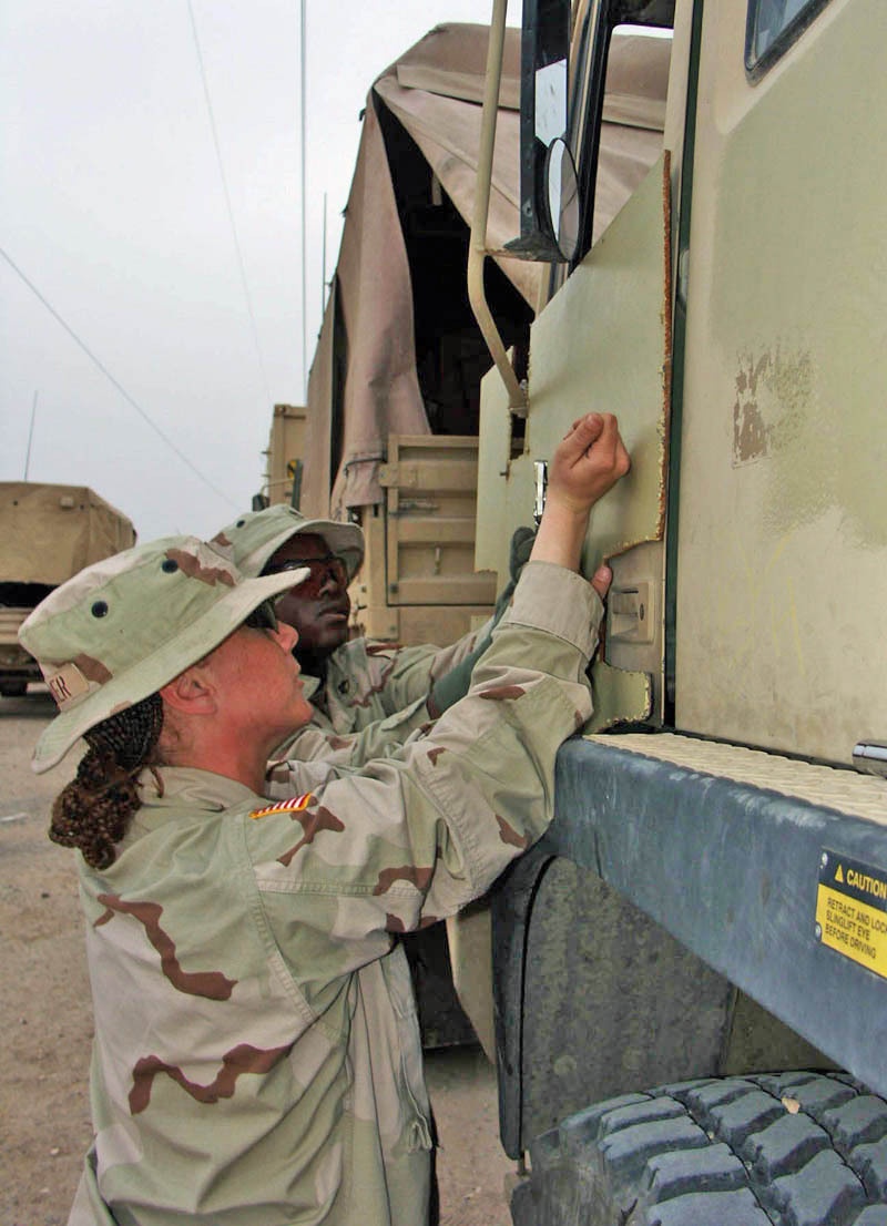 Soldiers begin removing the (homemade) armor