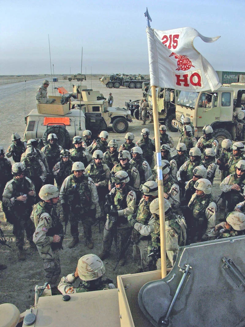 Soldiers listen to a convoy safety brief before continuing