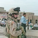 SSgt. Daniel D. Gililland works with an Iraqi policeman