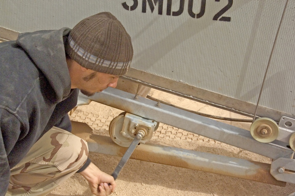 Kris Kokkeby sets up the launching device for the ScanEagle UAV