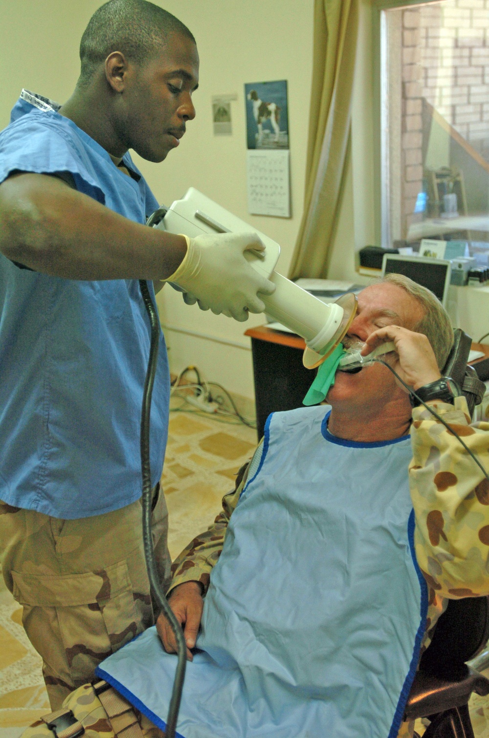 Brian Macklan takes an oral X-ray of Maj. John McPherson