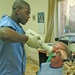 Brian Macklan takes an oral X-ray of Maj. John McPherson