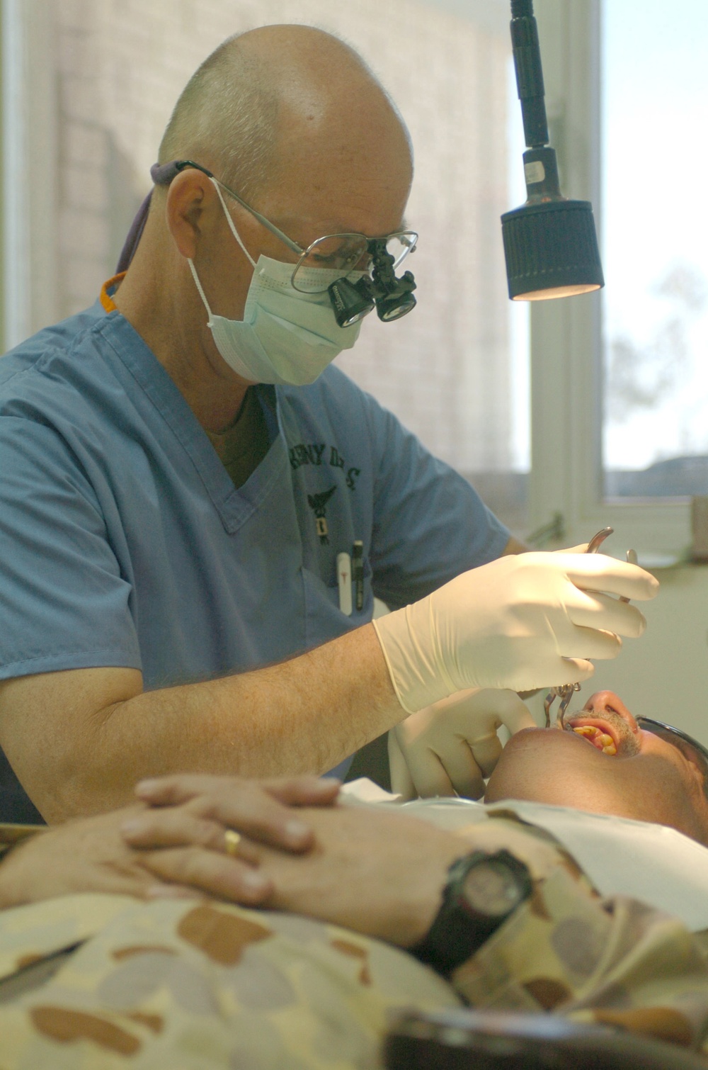 Col. Kraig Kenny performs root canal on Maj. John McPherson