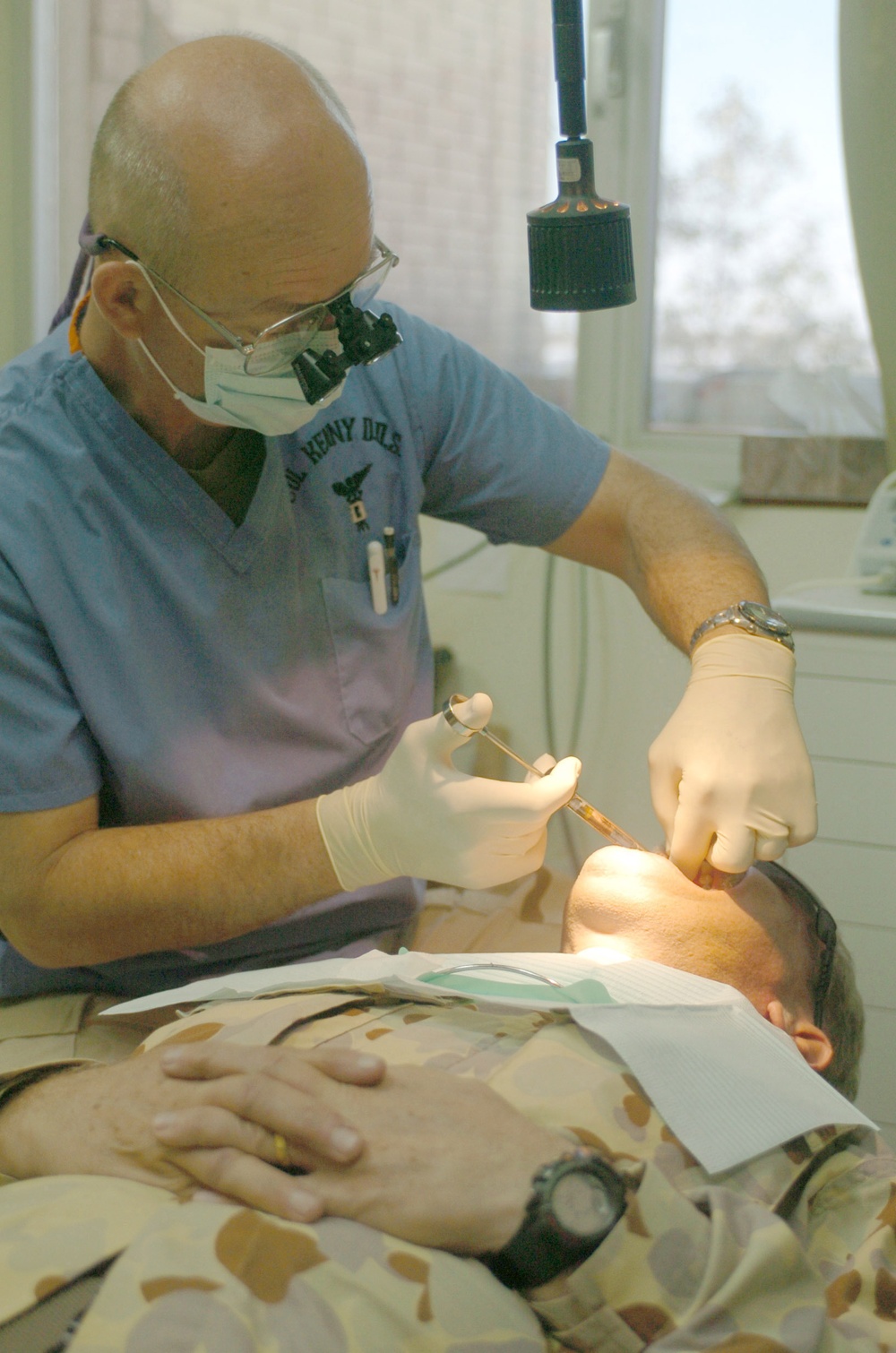 Col. Kenny performs a root canal on Maj. John McPherson