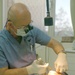 Col. Kenny performs a root canal on Maj. John McPherson