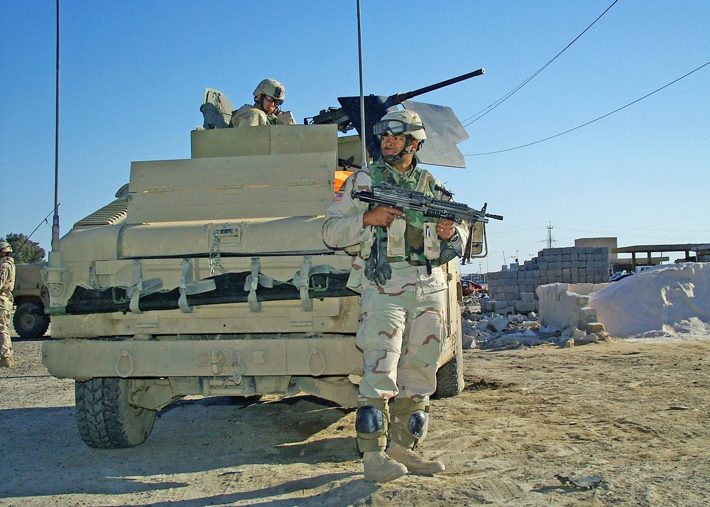 Sgt. Michael Saina Provides Security Along a Road in Taji