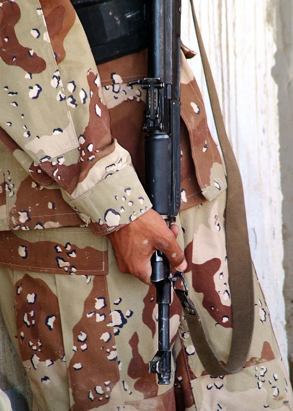 An Iraqi Army Soldier clutches his AK-47 assault rifle