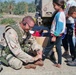 Spc. Jeff Sinclair Donates Sandals to an Iraqi Girl