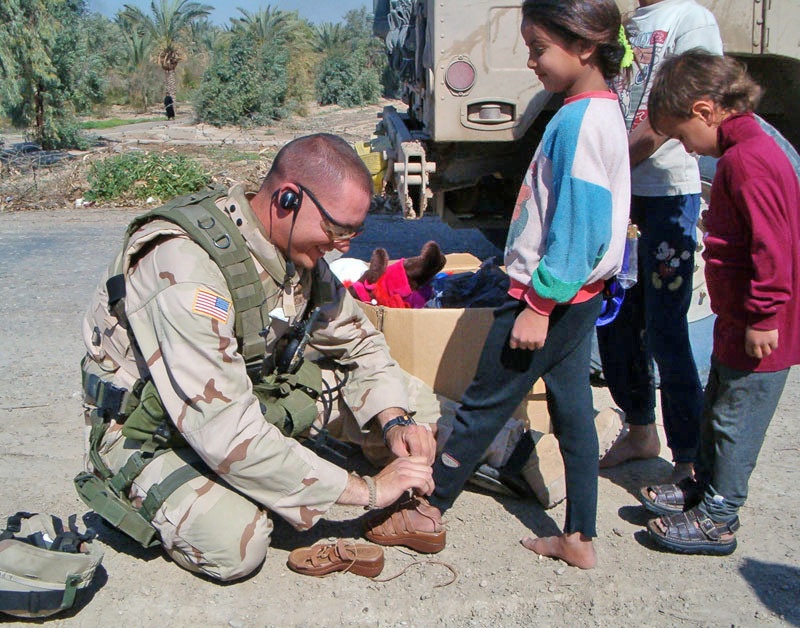 Spc. Jeff Sinclair Donates Sandals to an Iraqi Girl