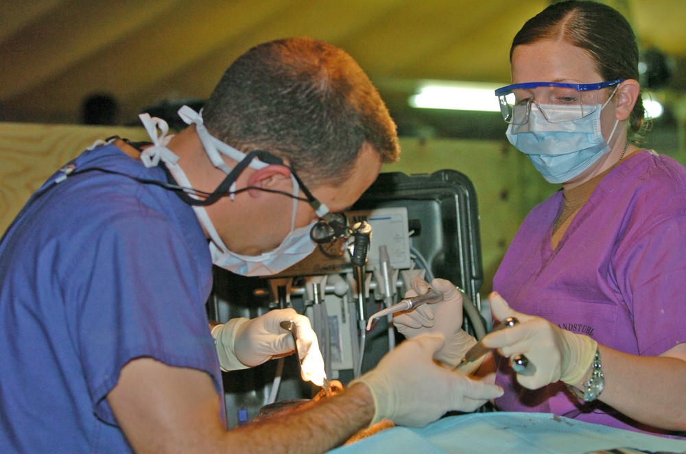 Pfc. Tiffany M. Shockley assists Capt. Michael R. Sanders