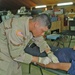 Pvt. Tyson rehydrates a Camp Bucca Internment Facility detainee