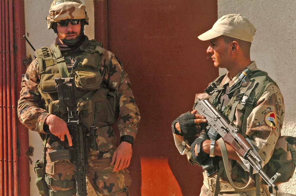 Two soldiers provide security at the entrance of a meeting