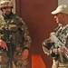 Two soldiers provide security at the entrance of a meeting