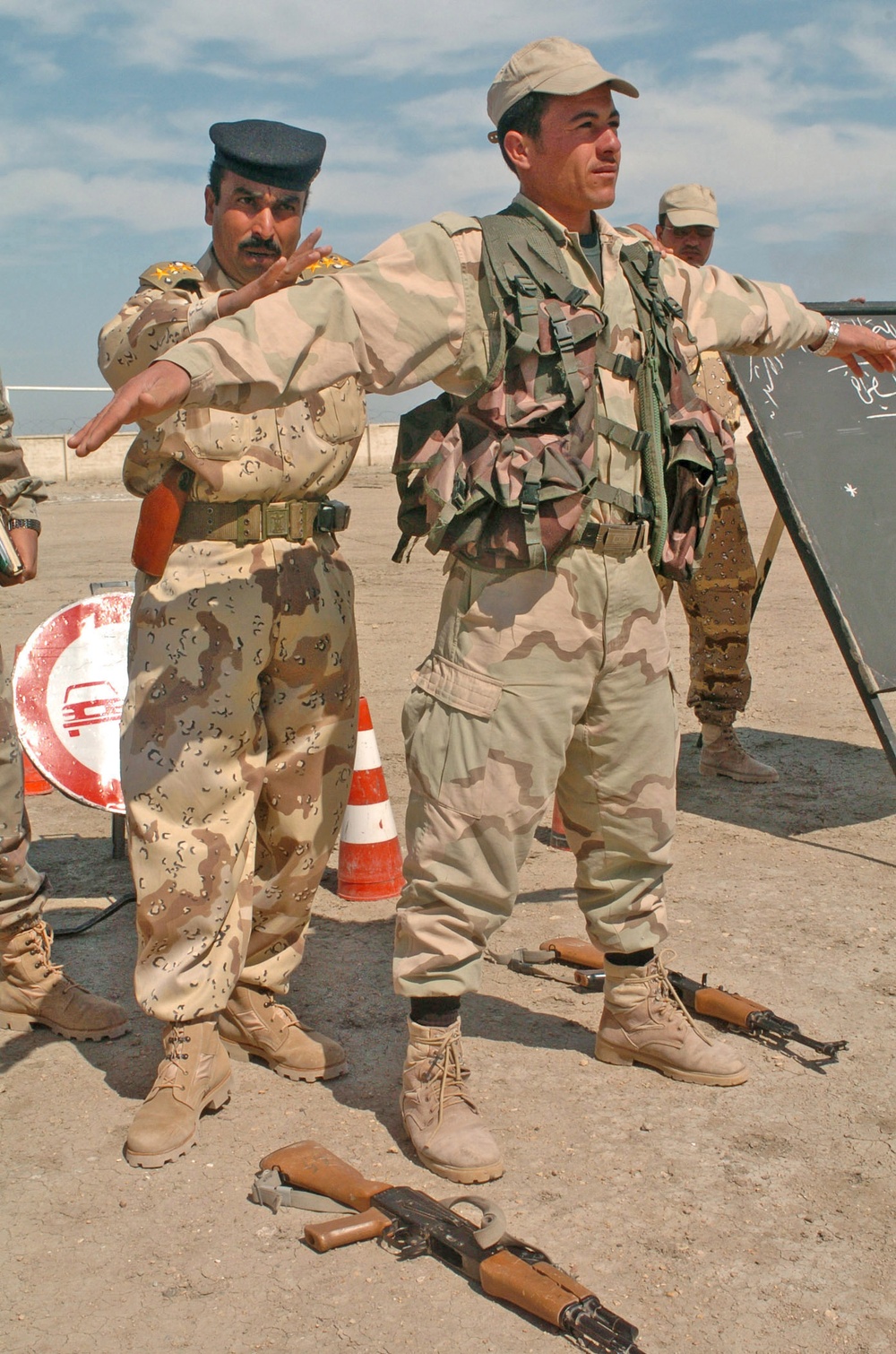 An Iraqi officer uses one of his soldiers to demonstrate