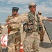 An Iraqi officer uses one of his soldiers to demonstrate