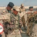 Two Iraqi officers use their soldiers to demonstrate