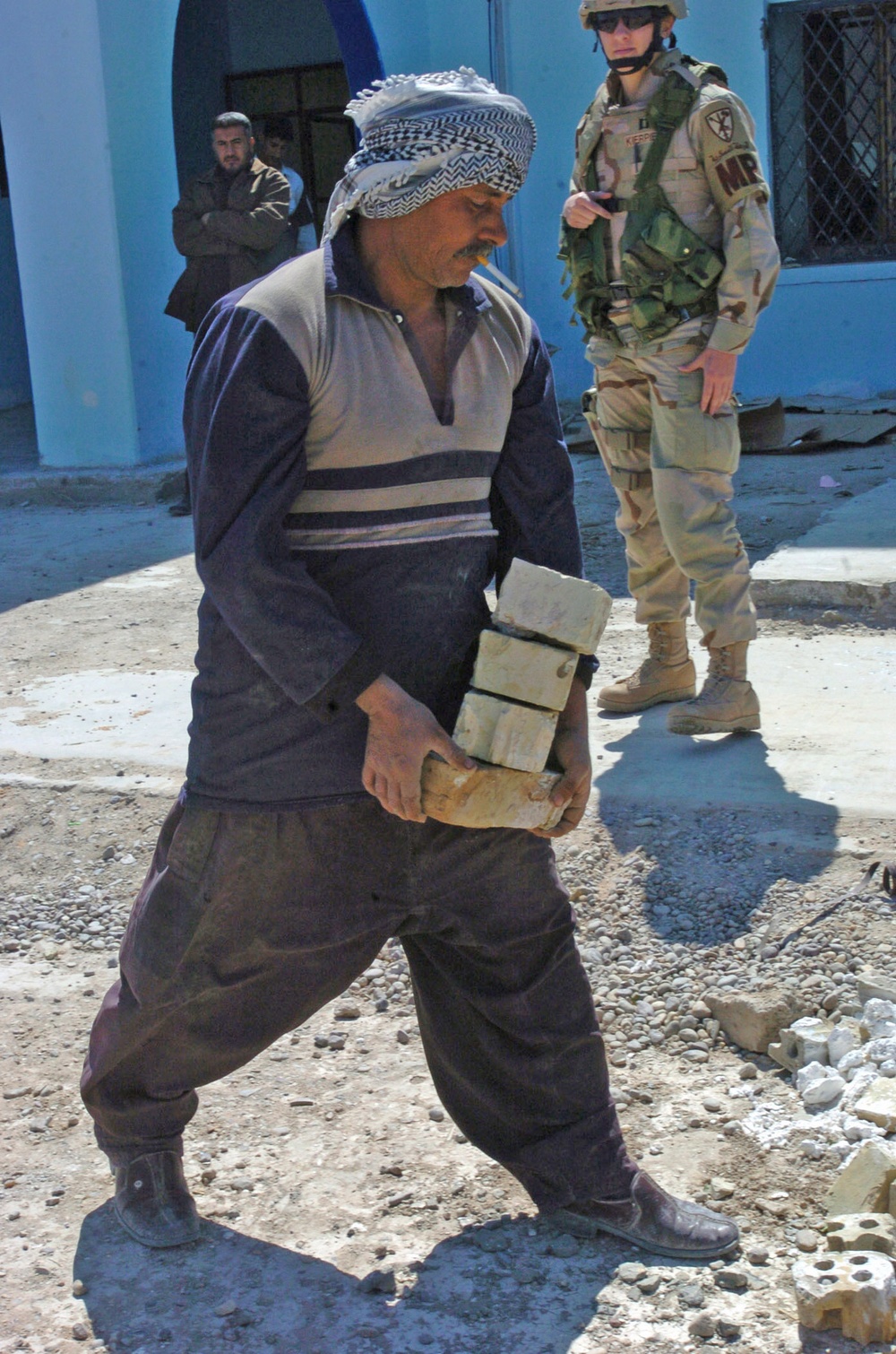 An Iraqi worker helps in the rebuilding