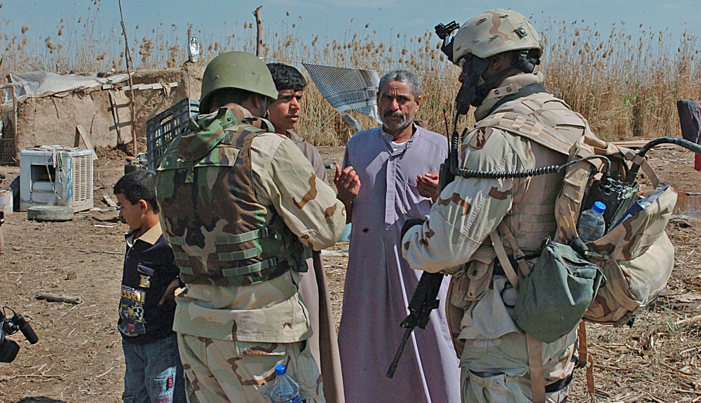 Staff Sgt. Stevie Knox talk with an Iraqi farmer