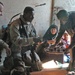 An Iraqi farmer, pours tea for Staff Sgt. Stevie Knox