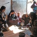 An Iraqi farmer, pours tea for Staff Sgt. Stevie Knox