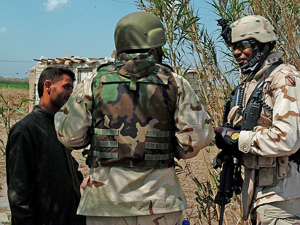 Staff Sgt. Stevie Knox talk with an Iraqi farmer