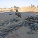 SFC Ware sits in front of a captured weapons cache