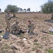 Soldiers provide medical assistance to a wounded insurgent