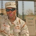 Spc. Daniel Willis Sits Outside the Chapel on Camp Victory