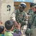 Soldiers hand out hard candy to kids in Sadr City