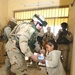 Chaplain hands a pair of sneakers and a coloring book
